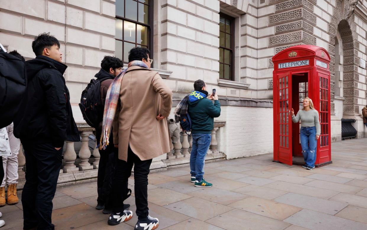 Tourists queue at the phone boxes in Parliament Square. For Chopperâ€™s Peterborough column. Jamie Lorriman