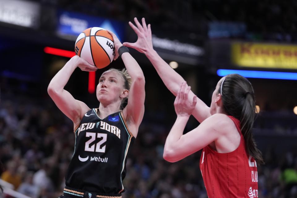 New York Liberty's Courtney Vandersloot (22) shoots over Indiana Fever's Caitlin Clark (22) during the first half of a WNBA basketball game, Saturday, July 6, 2024, in Indianapolis. (AP Photo/Darron Cummings)