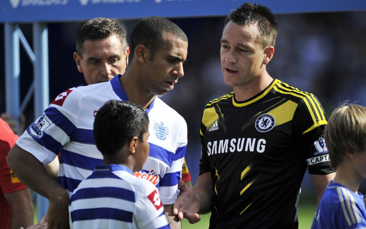 Queens Park Rangers' English defender Anton Ferdinand (L) avoids shaking hands with Chelsea's English defender John Terry (R) - AFP