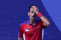 Novak Djokovic, of Serbia, reacts during the bronze medal match of the tennis competition against Pablo Carreno Busta, of Spain, at the 2020 Summer Olympics, Saturday, July 31, 2021, in Tokyo, Japan. (AP Photo/Seth Wenig)