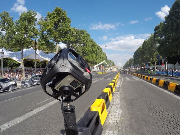 GoPro camera mounted on guard rails at a motorsports event.