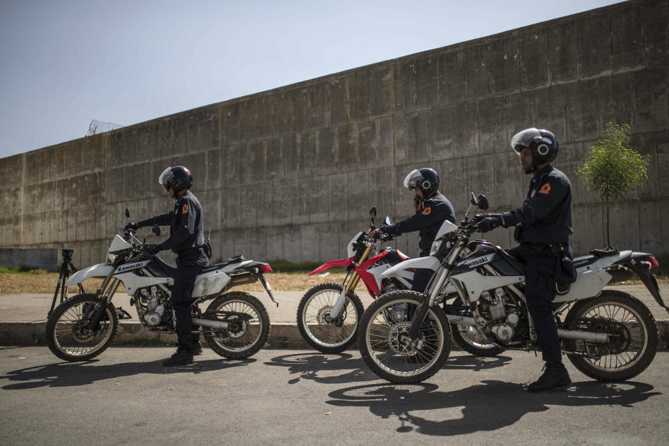 Security forces stand guard as suspects charged in connection with the killing of two Scandinavian tourists in Morocco's Atlas Mountains, arrive for a final trial session in Sale, near Rabat, Morocco, Thursday, July 18, 2019. The three main defendants in the brutal slaying of two female Scandinavian hikers have asked for forgiveness from Allah ahead of a verdict. (AP Photo/Mosa'ab Elshamy)