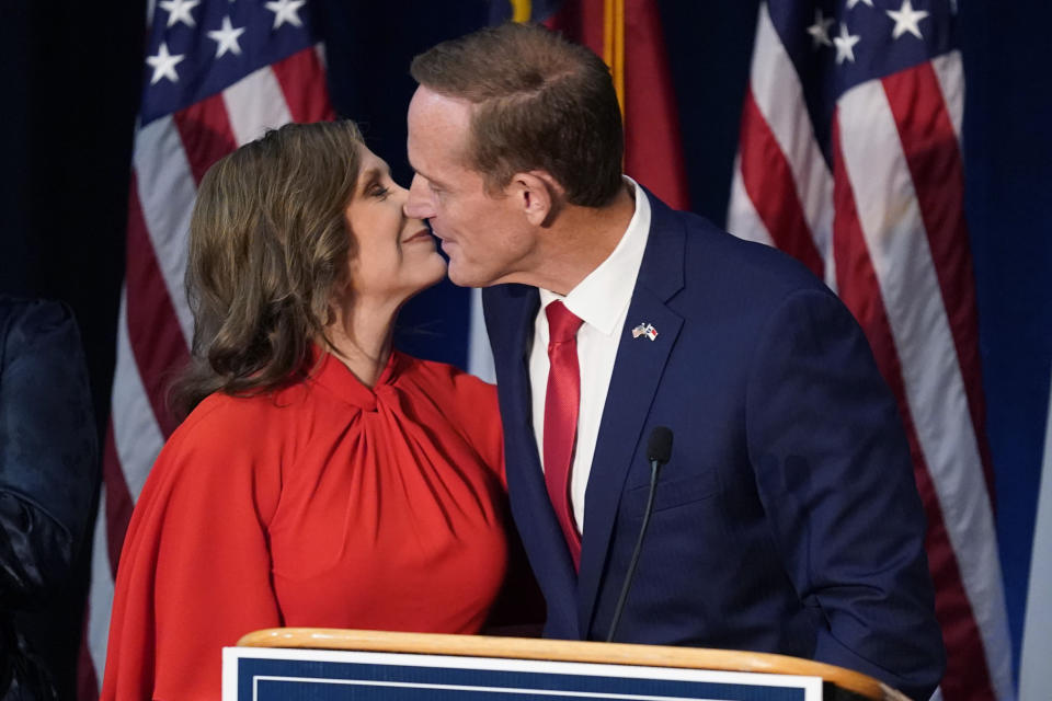 Rep. Ted Budd, R-N.C)., kisses his wife Amy Kate, left, after winning his U.S. Senate race against Cheri Beasley at his election night watch party in Winston-Salem, N.C., Tuesday, Nov. 8, 2022. (AP Photo/Chuck Burton)