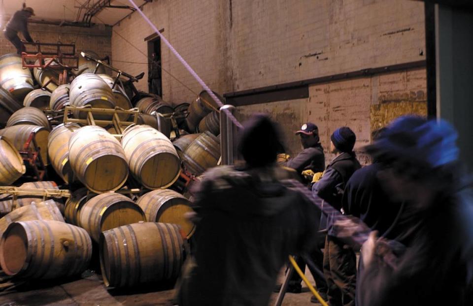 Workers at Turley Wine Cellars in Templeton recover oak barrels of the 2002 vintage. The San Simeon Earthquake knocked over racks of full 60 gallon barrels. Workers rappel in, pump out the wine and send the barrel out on a rope then repeat the process Dec. 23, 2003.