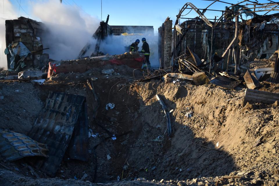 Members of the Ukrainian State Emergency Service clear the rubble at the building which was destroyed as a result of Russian strike in Zaporizhzhia (AP)