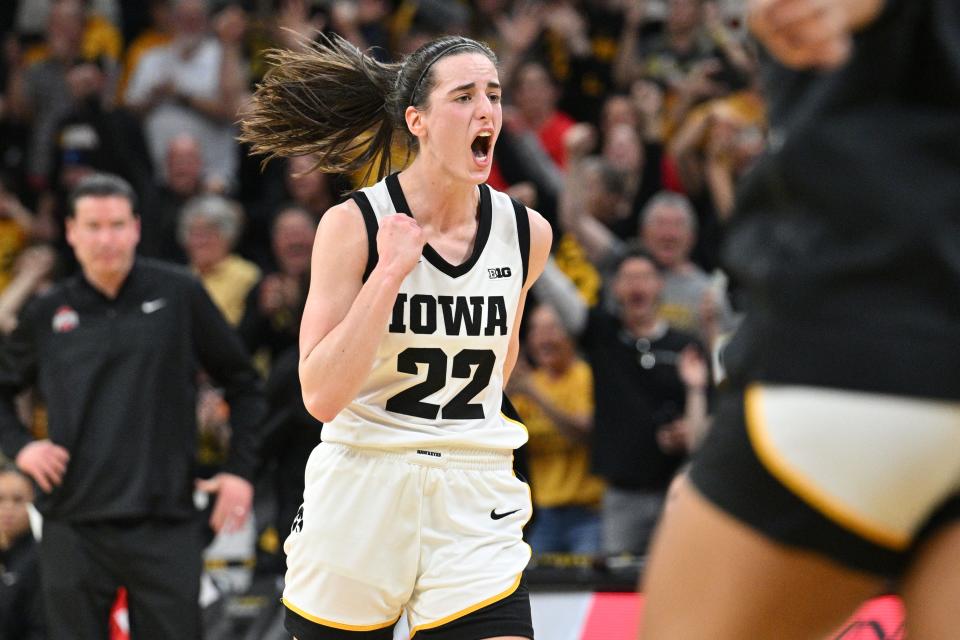 Iowa guard Caitlin Clark reacts after breaking the NCAA Division I all-time scoring record during the second quarter against Ohio State, March 3, 2024 in Iowa City, Iowa.