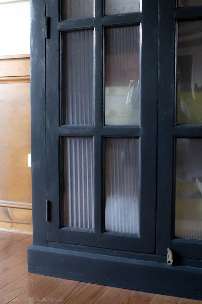 Close-up look at reeded glass film installed in the glass doors of a vintage cabinet