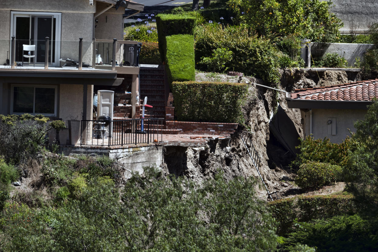 A partially destroyed patio caused by earth movement is seen in Southern California's Palos Verdes Peninsula's Rolling Hills Estates, Calif. on Monday, July 10, 2023. The Los Angeles County city of Rolling Hills Estates were hastily evacuated by firefighters Saturday when cracks began appearing in structures and the ground. (AP Photo/Richard Vogel)