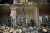 Yousef Hayeni stands in front of the remains of his house following an air strike in the Syrian town of Aazaz, near the northern restive city of Aleppo. UN investigators said Wednesday the Syrian regime has committed crimes against humanity, including the Houla massacre, as two dozen people were reported killed in a devastating air strike in the north