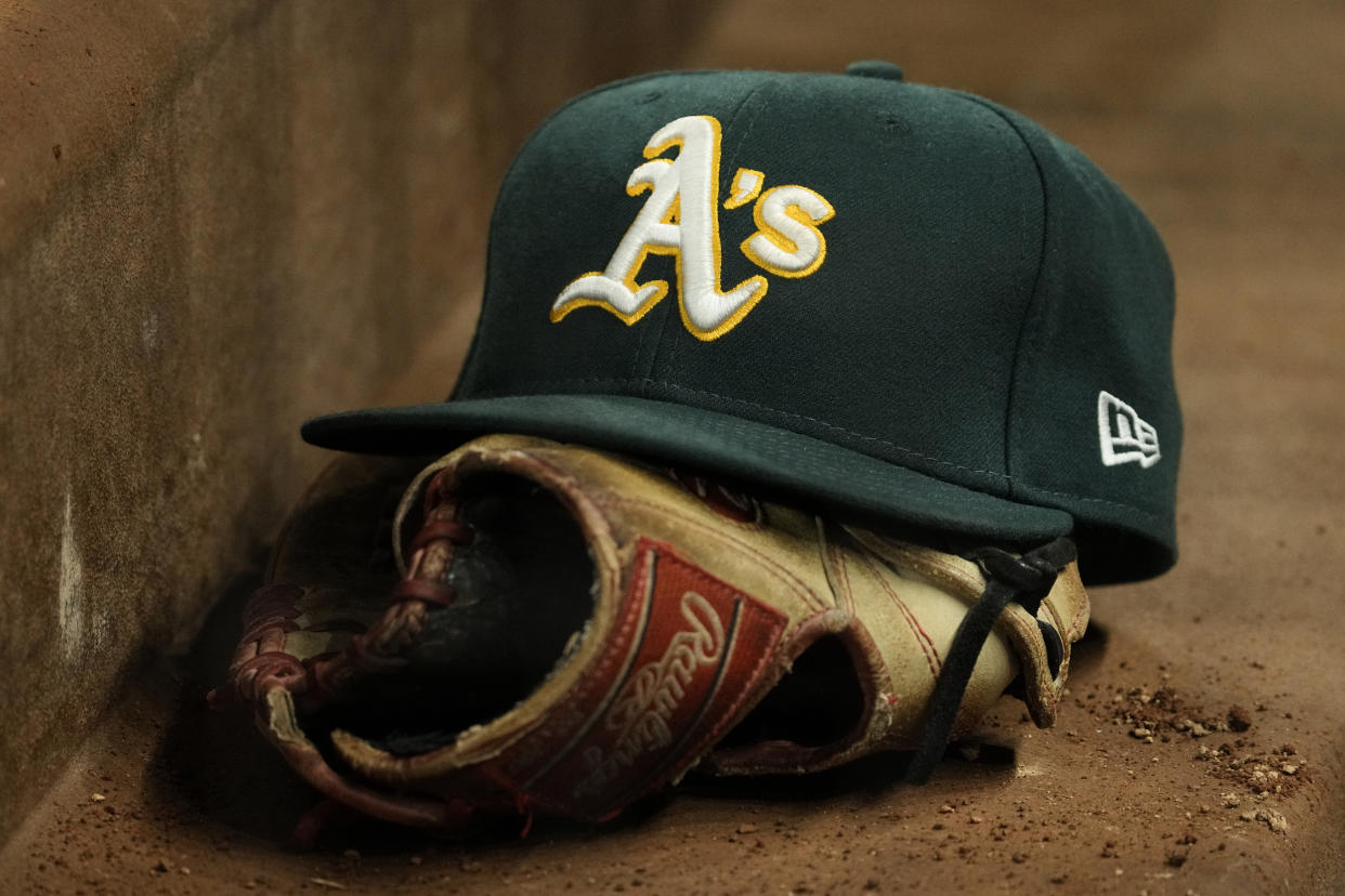 ARLINGTON, TEXAS - APRIL 21: A close up view of an Oakland Athletics hat and Rawlings glove during the game against the Texas Rangers at Globe Life Field on April 21, 2023 in Arlington, Texas. (Photo by Sam Hodde/Getty Images)