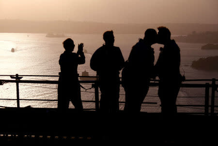 Warren Orlandi and Pauly Phillips kiss after they became the first same-sex couple to marry atop of the Sydney Harbour Bridge, just two days out from the 40th anniversary of the Sydney Gay and Lesbian Mardi Gras, in Australia, March 1, 2018. REUTERS/David Gray