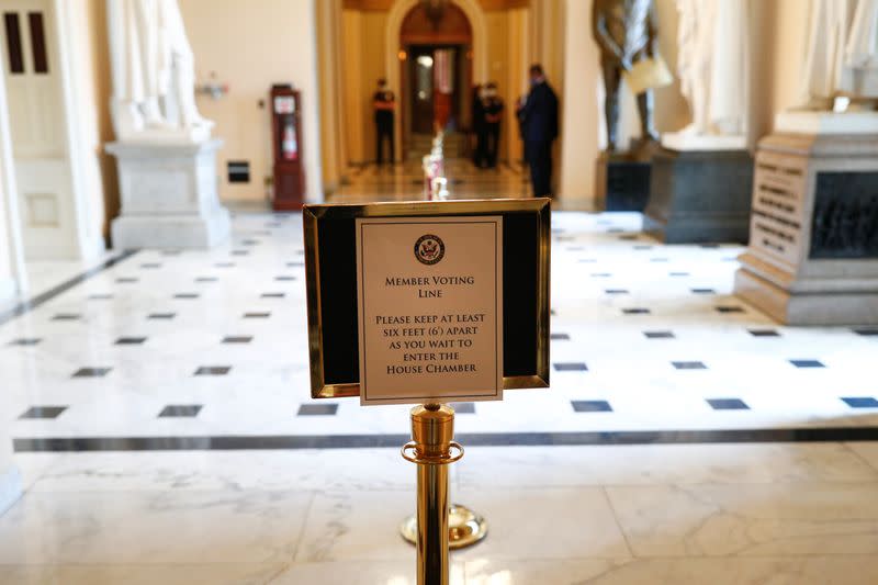 A sign indicating proper social distancing measures is displayed ahead of House vote on coronavirus relief bill in Washington