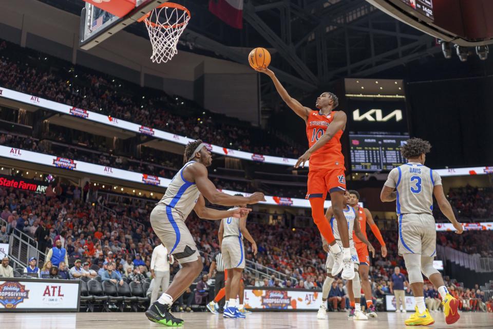 Auburn guard Chance Westry (10) attempts a basket against a Memphis defender during the first half of an NCAA college basketball game on Saturday, Dec. 10, 2022, in Atlanta, Ga. (AP Photo/Erik Rank)