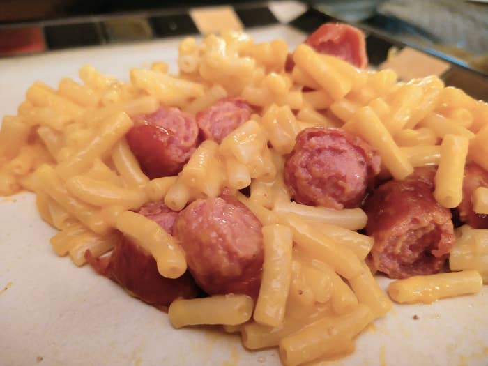 Mac 'n' cheese with sliced hot dog.