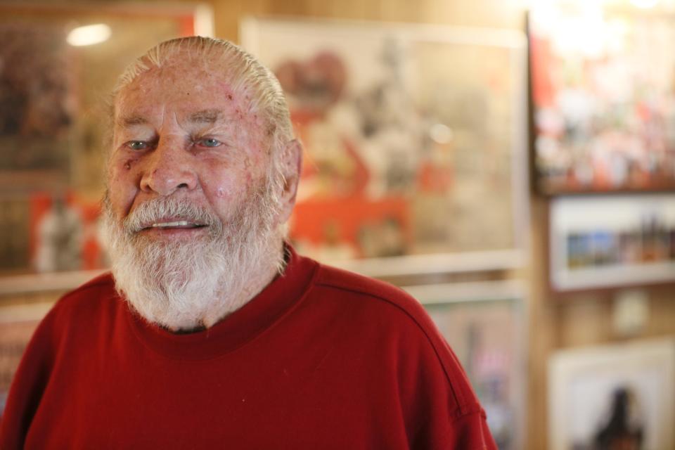 Harry Welch, 92, who played football for the University of Southern California in the 1953 Rose Bowl, shows his basement full of newspaper clippings photographs and other items.