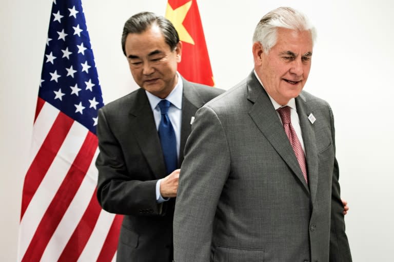 US Secretary of State Rex Tillerson (R) and China's Foreign Minister Wang Yi walk to their seats before a meeting on the sidelines of a gathering of G20 foreign ministers in Bonn, western Germany, on February 17, 2017