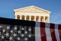 A U.S. flag is seen during a demonstration before a vote on the nomination of Amy Coney Barrett to the Supreme Court in Washington