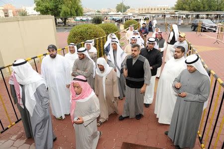 Kuwaiti men arrive to cast their votes during parliamentary election in a polling station in Kuwait City, Kuwait November 26, 2016. REUTERS/Stringer