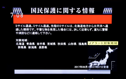  The Japanese government's alert message called J-alert notifying citizens of a ballistic missile launch by North Korea is seen on a television screen in Tokyo - Credit: Reuters