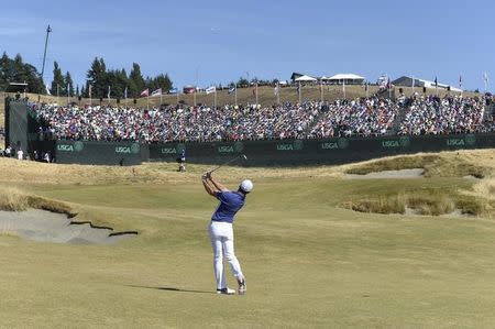 Jun 21, 2015; University Place, WA, USA; Rory McIlroy plays his approach shot to the 18th hole in the final round of the 2015 U.S. Open golf tournament at Chambers Bay. Mandatory Credit: Michael Madrid-USA TODAY Sports