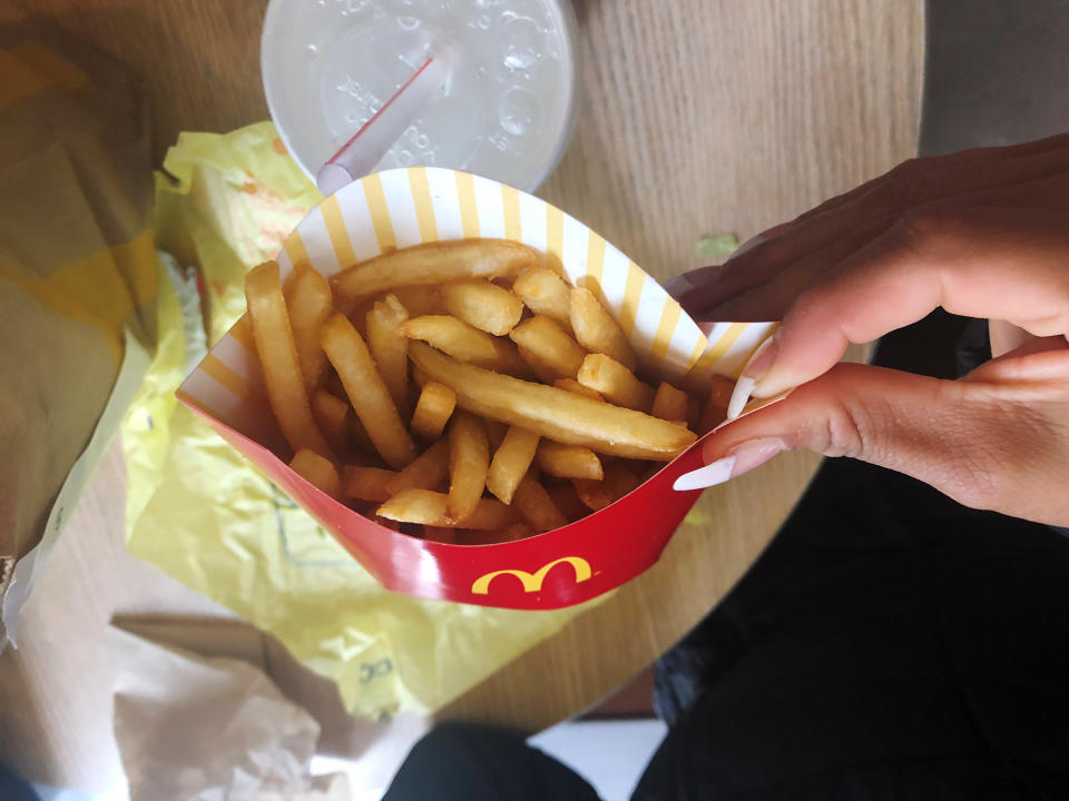  A McDonald's customer shows her french fries box at the fast-food chain McDonald's in New York, U.S., October 22, 2019. REUTERS/Shannon Stapleton