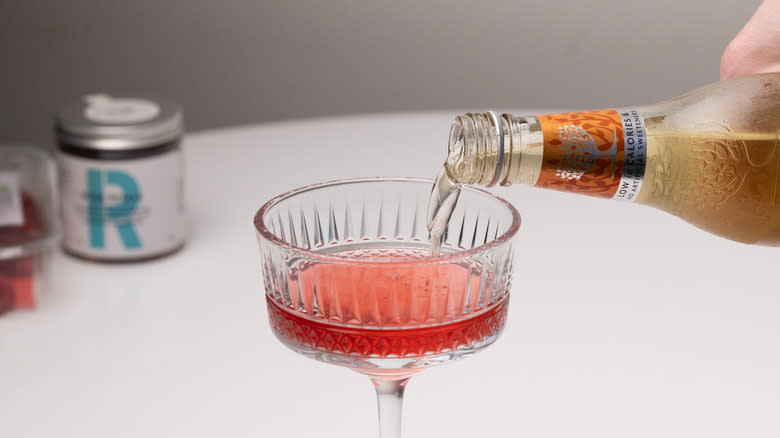 pouring ginger ale into glass