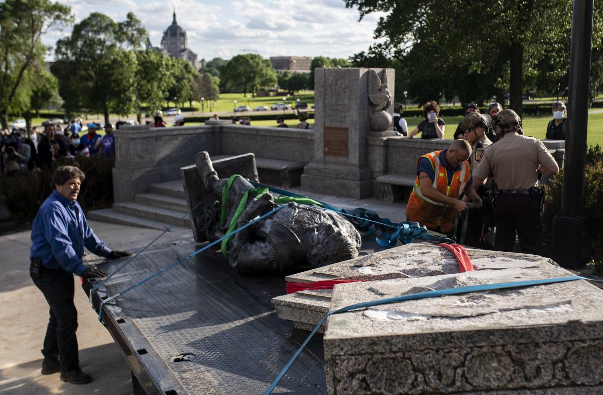 A statue of Christopher Columbus, which was toppled to the ground by protesters, is loaded onto a truck on the grounds of the State Capitol on June 10, 2020 in St Paul, Minn.