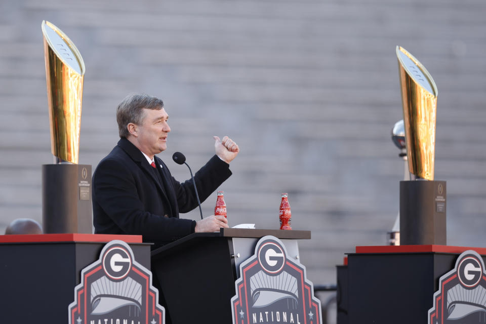 Georgia head coach Kirby Smart speaks while standing between the 2022 and 2023 championship trophies during a ceremony celebrating the Bulldog's second consecutive NCAA college football national championship, Saturday, Jan. 14, 2023, in Athens, Ga. (AP Photo/Alex Slitz)