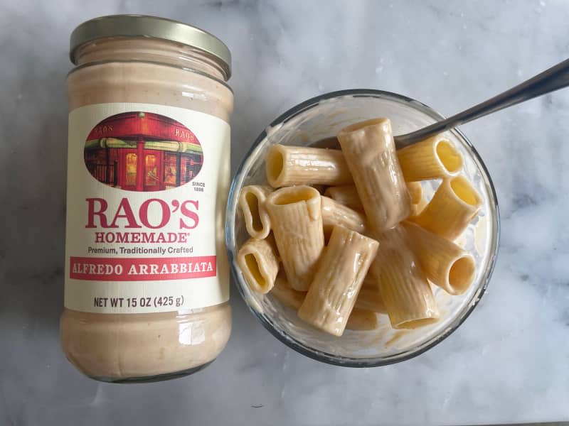 Rao's new sauces taste test: jar of Alfredo Arrabbiata sauce on counter next to bowl of rigatoni