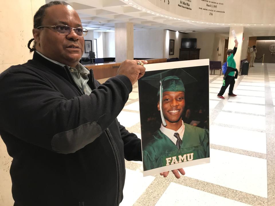 Harvey Johnson holds a picture of his son, 22-year-old Jamee Johnson, following a new conference on Jan. 30, 2020, at the Capitol. Harvey Johnson and family members were joined by members of the Legislative Black Caucus in asking FDLE to investigate the fatal police-involved shooting of Jamee in Jacksonville.