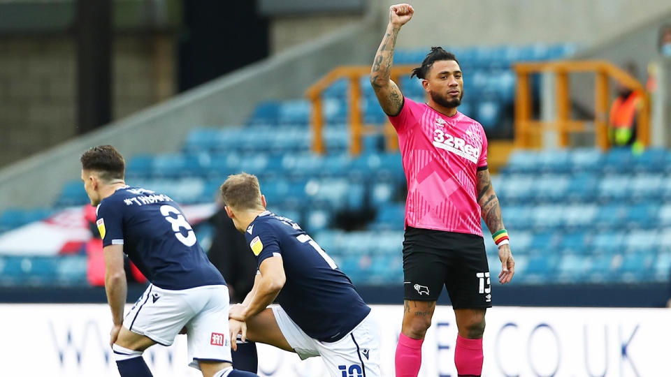 Colin Kazim-Richards of Derby County raises his right fist as other players take the knee prior to their match against Millwall, in response to Millwall fans booing the players. (Photo by Jacques Feeney/Getty Images)
