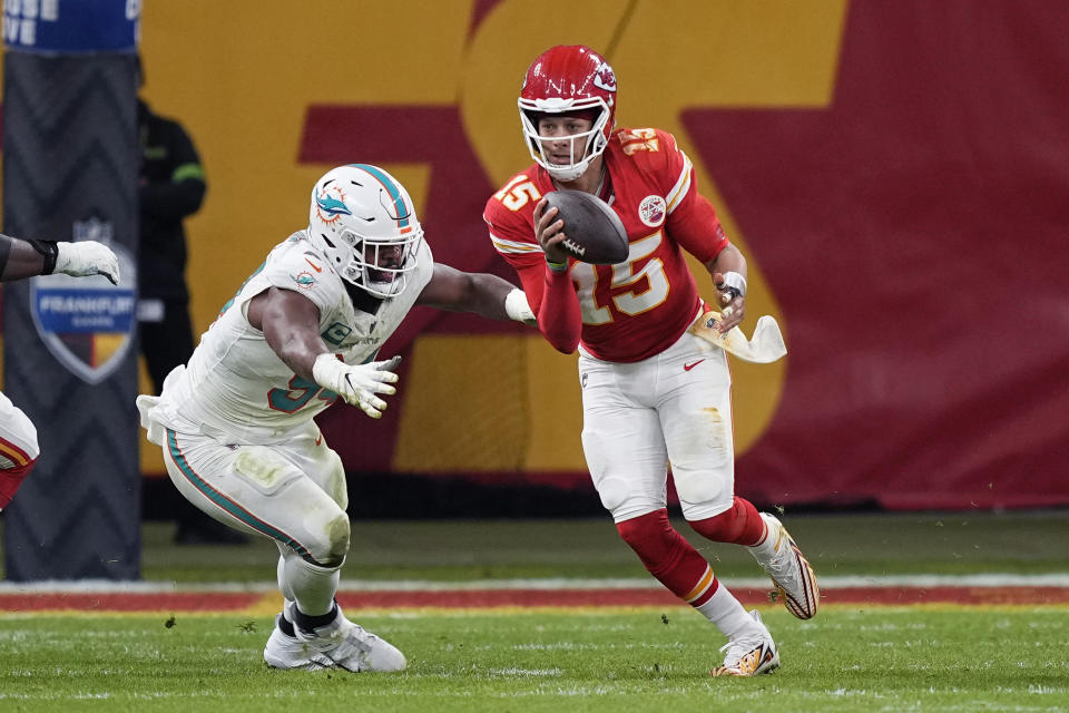 Kansas City Chiefs quarterback Patrick Mahomes (15) scrambles away from Miami Dolphins defensive tackle Christian Wilkins during the first half of an NFL football game Sunday, Nov. 5, 2023, in Frankfurt, Germany. (AP Photo/Martin Meissner)