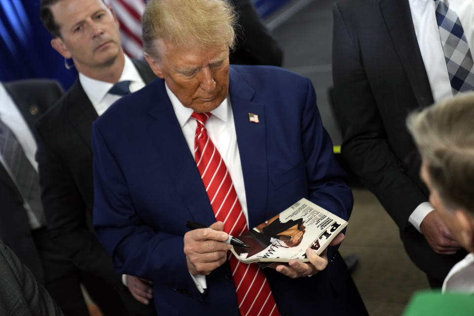 Republican presidential candidate former President Donald Trump signs autographs after speaking at a rally at Des Moines Area Community College in Newton, Iowa, Saturday, Jan. 6, 2024. (AP Photo/Andrew Harnik)