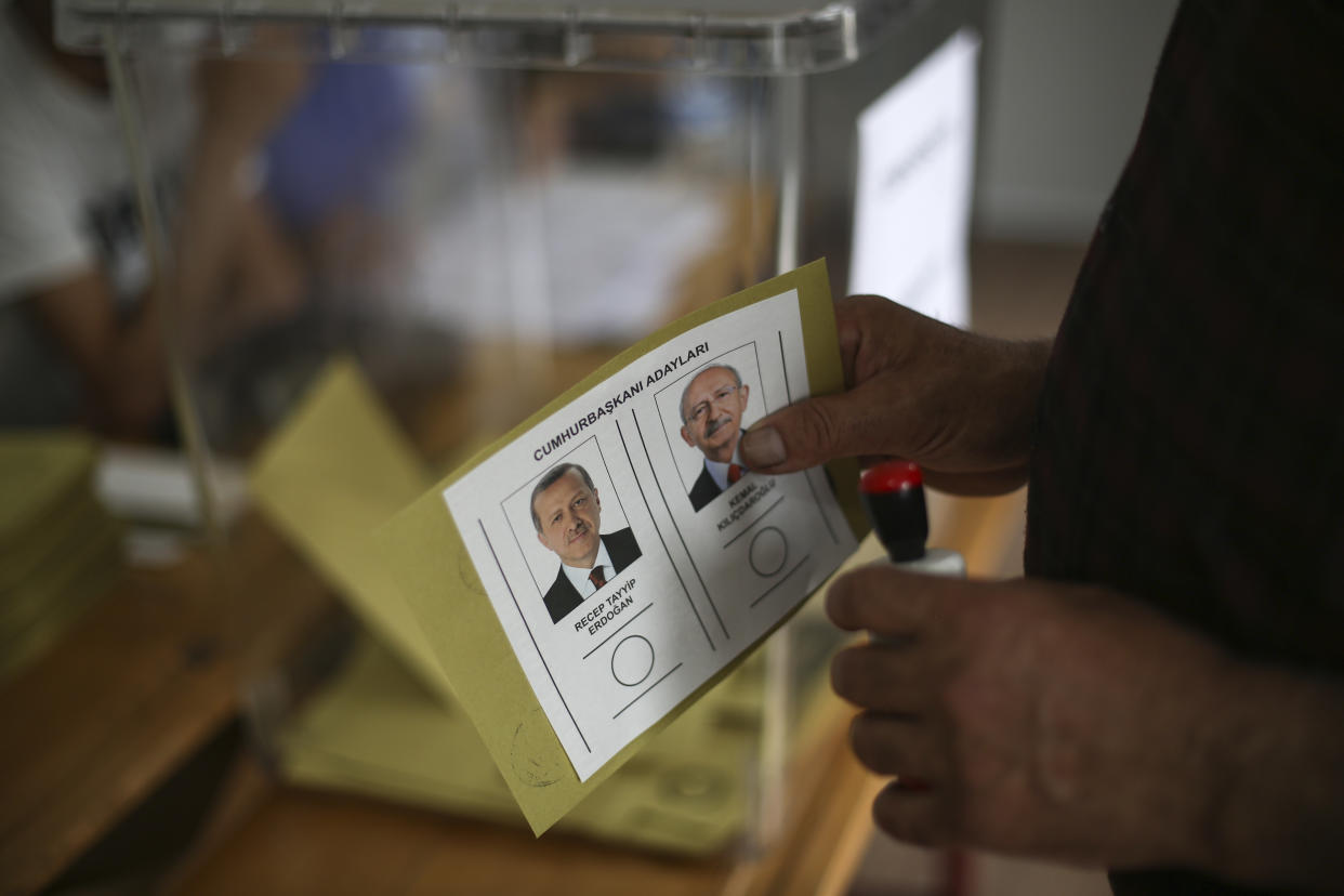 A man holds a ballot with the names and images of two presidential candidates, Recep Tayyip Erdogan, left, and Kemal Kilicdaroglu, before voting at a polling station, in Malatya, Turkey, Sunday, May 28, 2023. Voters in Turkey returned to the polls Sunday to decide whether the country's longtime leader, Erdogan, stretches his increasingly authoritarian rule into a third decade or is unseated by a challenger who has promised to restore a more democratic society. (Hakan Akgun/dia Images via AP)