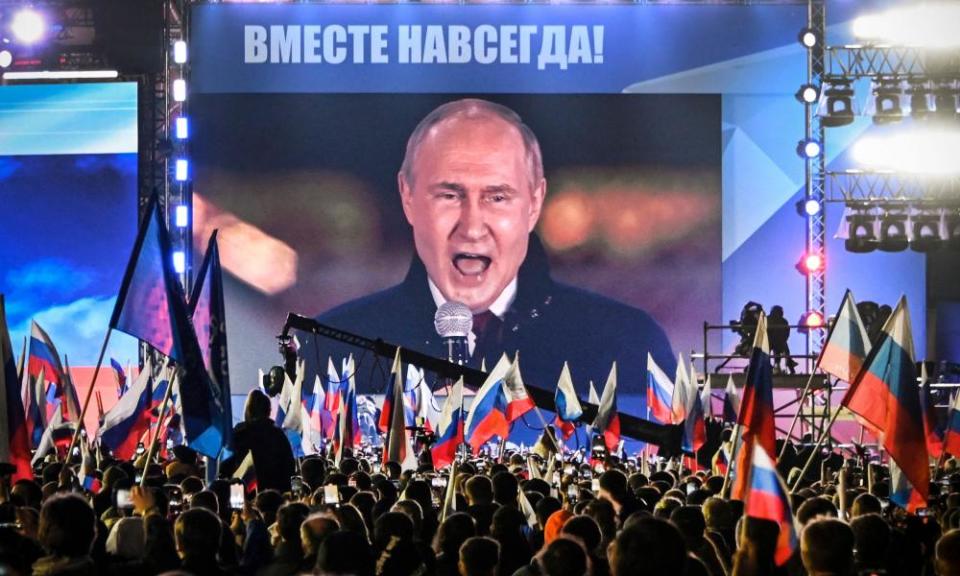 An image of Russian president Vladimir Putin appears on a screen in Moscow’s Red Square 