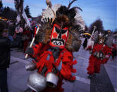 Kukeri leave the main square after the grand parade and performances. More than 5,000 people take part in the annual festival from 90 folklore groups (Amos Chapple / Rex Features)