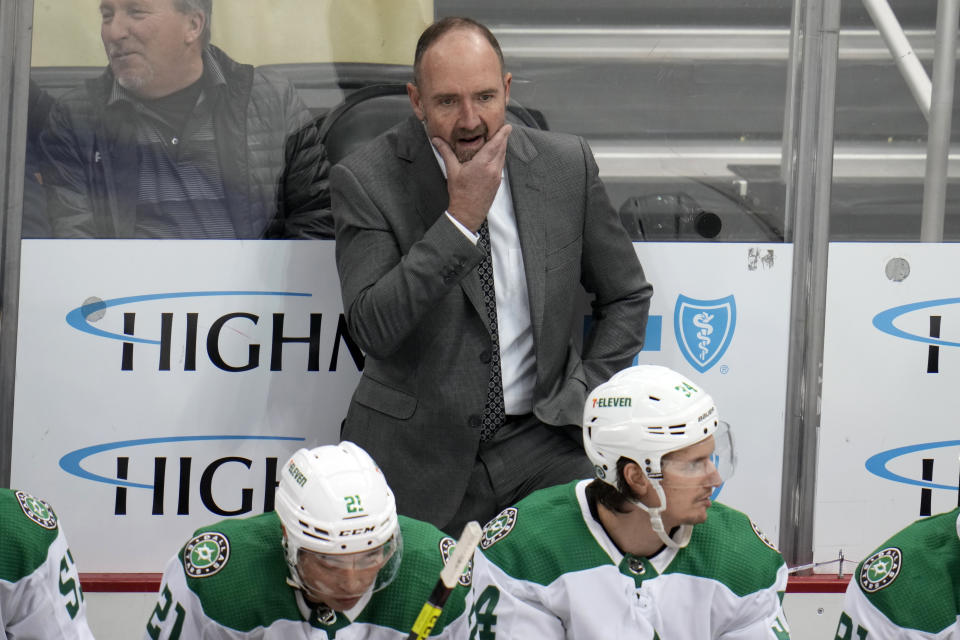 Dallas Stars head coach Peter Deboers stands behind his bench during the third period of an NHL hockey game against the Pittsburgh Penguins in Pittsburgh, Monday, Dec. 12, 2022. The Penguins won 2-1. (AP Photo/Gene J. Puskar)