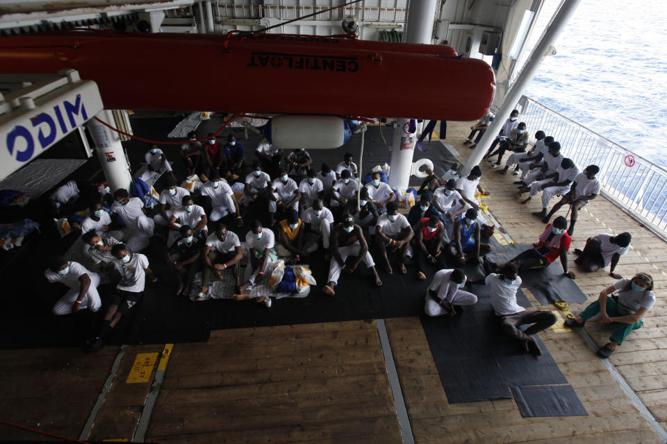 African migrants listen to instructions from Doctors Without Borders workers abroad the Geo Barents vessel after they were rescued in the Mediterranean Sea off Libya, Thursday, Sept. 23, 2021. Migrants say that they were tortured and their families extorted for ransoms in Libya’s detention centers. (AP Photo/Ahmed Hatem)