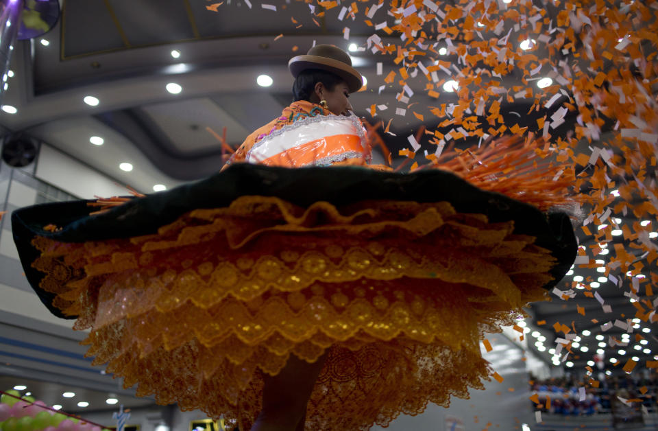 A women competes in the Queen of the Great Power contest, in La Paz, Bolivia, Friday, May 24, 2019. The largest religious festival in the Andes choses its queen in a tight contest to head the Festival of the Lord Jesus of the Great Power, mobilizing thousands of dancers and more than 4,000 musicians into the streets of La Paz. (AP Photo/Juan Karita)