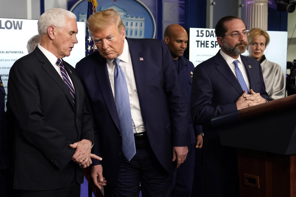 President Donald Trump listens to Vice President Mike Pence, left, as Health and Human Services Secretary Alex Azar speaks during a press briefing with the coronavirus task force, in the Brady press briefing room at the White House, Monday, March 16, 2020, in Washington. (AP Photo/Evan Vucci)