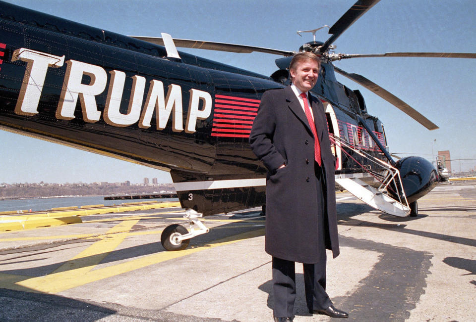 <p>Donald Trump poses in front of one of three Sikorsky helicopters at New York Port Authority’s West 30 Street heliport on March 22, 1988. <i>(Photo: Wilbur Funches/AP)</i> </p>