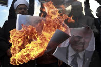 <p>Palestinians burn posters of Israeli Prime Minister Benjamin Netanyahu and President Donald Trump, during a protest against the U.S. decision to recognize Jerusalem as Israel’s capital, in Gaza City Thursday, Dec. 7, 2017. (Photo: Khalil Hamra/AP) </p>