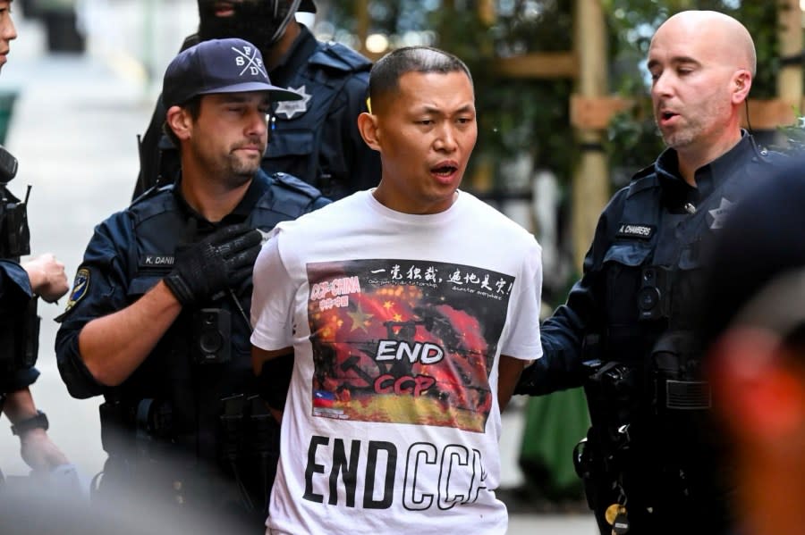 A demonstrator is detained by police while protesting the participation of China’s President Xi Jinping outside the Asia-Pacific Economic Cooperation (APEC) conference, Thursday, Nov. 16, 2023, in San Francisco. (AP Photo/Noah Berger)