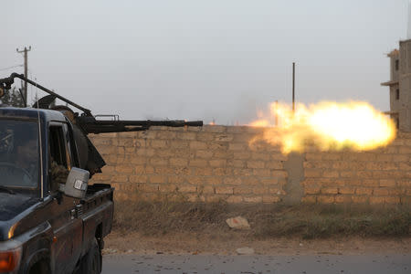 Members of the Libyan internationally recognised government forces fire during fighting with Eastern forces in Ain Zara, Tripoli, Libya April 20, 2019. REUTERS/Hani Amara