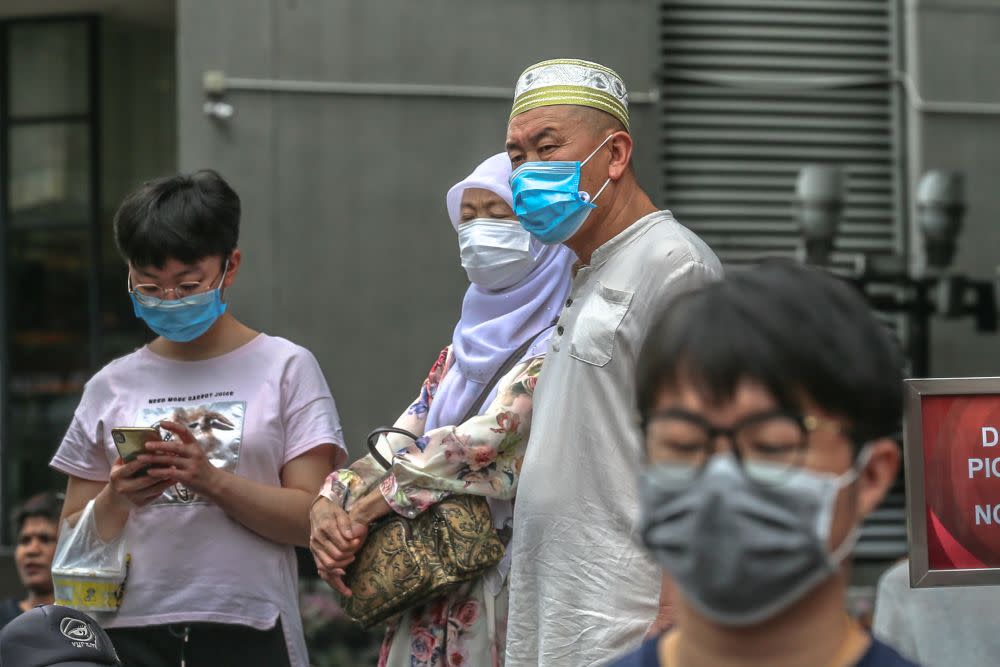 People wearing face masks are pictured outside Pavilion Kuala Lumpur February 10, 2020. — Picture by Firdaus Latif