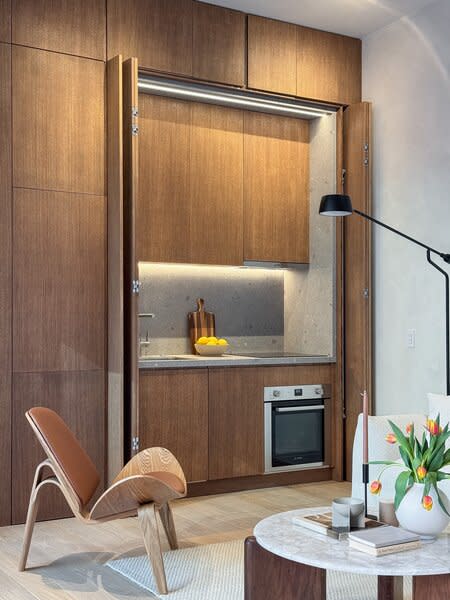 The kitchenette, which has a cooktop and oven, can also be concealed when not in use.