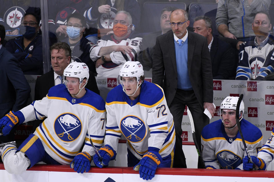 Buffalo Sabres head coach Don Granato watches the action from the bench against the Winnipeg Jets during the third period of an NHL hockey game, Tuesday, Dec. 14, 2021 in Winnipeg, Manitoba. (Fred Greenslade/The Canadian Press via AP)