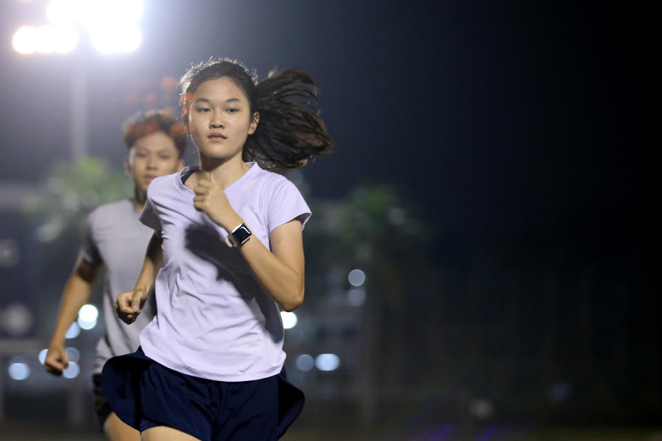 Asian young adults are running during athletic training in stadium