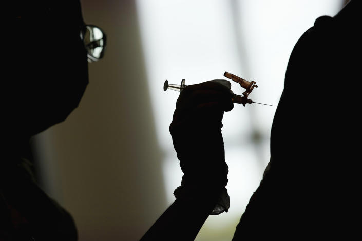 A nursing student administers the Moderna COVID-19 vaccine at a vaccination center at UNLV, in Las Vegas in 2021. (John Locher/AP)