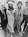 <p>Mick Jagger and Bianca Jagger attempted to keep their St. Tropez nuptials a secret, but once word spread that they were en route to the courthouse, photographers flocked to them. Bianca's outfit, a white Yves Saint Laurent suit and veiled wide-brimmed hat, is iconic today.</p>